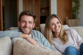 Smiling guests relaxing in a modern living room